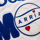 Close-up of a personalized Soccer Mom design with blue twill appliqué, a white leather soccer ball with laser-marked panel lines, embroidered name ARRIA, and red heart accents.