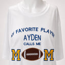Personalized Football Mom shirt with custom player name, embroidered MOM lettering, and real leather football applique.