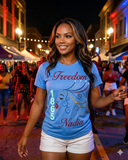 Juneteenth model/lifestyle image:
Woman wearing Juneteenth Freedom 1865 T-shirt at community celebration