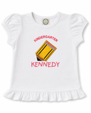 Personalized white girls’ ruffle shirt with embroidered Kindergarten, Light Gold pencil appliqué, and name Kennedy