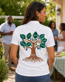Woman wearing a white personalized family reunion polo with a large embroidered family tree design on the back at an outdoor gathering