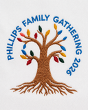 Close-up of a personalized family reunion polo left-chest logo with an embroidered family tree, colorful leaves, family name, and gathering year